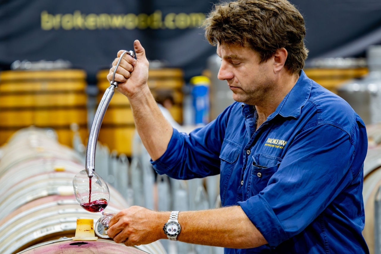 Winemaker sampling wine from the barrel at Brokenwood Wines in the Hunter Valley